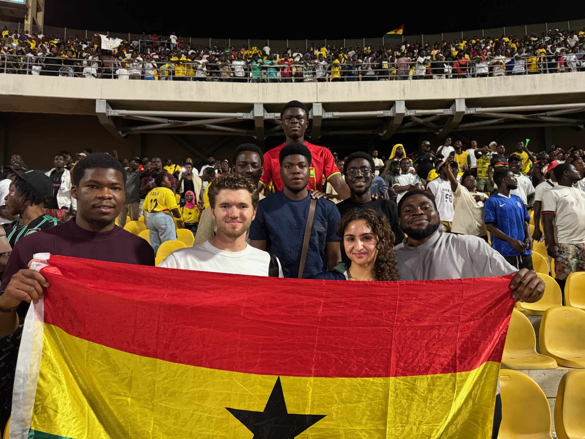 Justice and a friend at a national football match in Ghana.